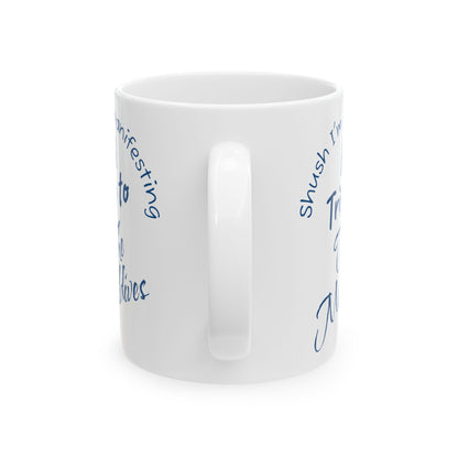 A Trip To The Maldives Ceramic Mug — 'Shush I'm Manifesting' In Blue On White Coffee Cup (11oz & 15oz)