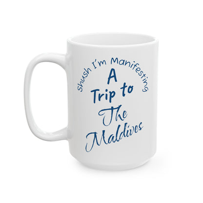 A Trip To The Maldives Ceramic Mug — 'Shush I'm Manifesting' In Blue On White Coffee Cup (11oz & 15oz)