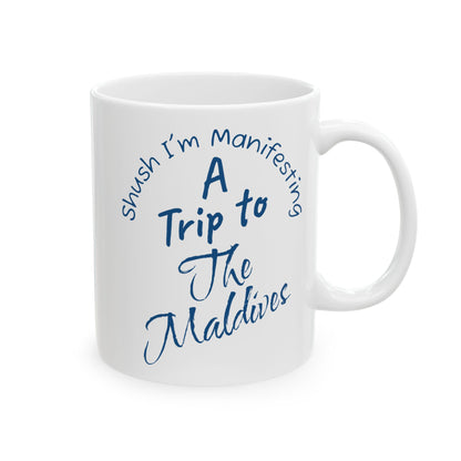 A Trip To The Maldives Ceramic Mug — 'Shush I'm Manifesting' In Blue On White Coffee Cup (11oz & 15oz)