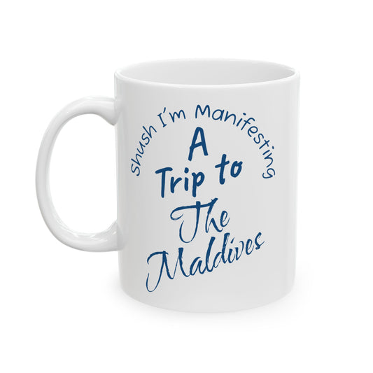 A Trip To The Maldives Ceramic Mug — 'Shush I'm Manifesting' In Blue On White Coffee Cup (11oz & 15oz)